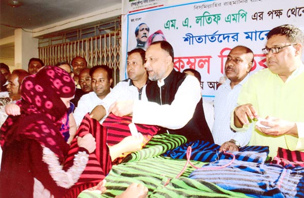 M A Latif MP distributing blankets among the cold -hit people in Chiitagong recently.