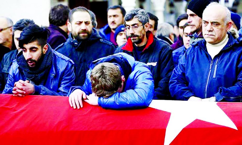 Relatives at the funeral of a victim of an attack by a gunman at the Reina nightclub, in Istanbul, Turkey.