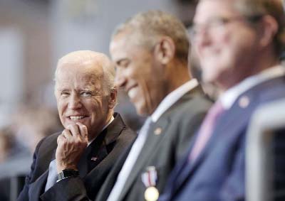 Vice President Joe Biden, left, watches President Barack Obama, centre, sitting with Defense Secretary Ash Carter, right, as they listen to Joint Chiefs Chairman Gen. Joseph Dunford talk about Obama during an Armed Forces Full Honor Farewell Review on Wed