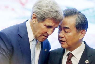 U.S. Secretary of State John Kerry and China's Foreign Minister Wang Yi talk at the 5th East Asia Summmit at the 48th Association of Southeast Asian Nations (ASEAN) foreign ministers meeting in Kuala Lumpur, Malaysia.