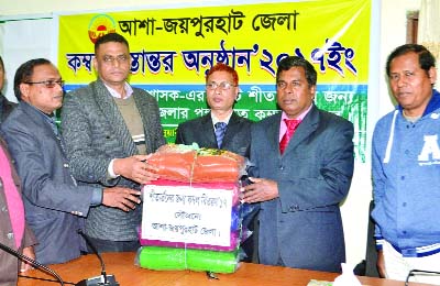 JOYPURHAT: Rafiqual Islam, Zonal Manager and Aftab Uddin, District Manager(Joypurhat), Asha distributing blankets for the cold -hit people to Abdur Rahim, DC on Wednesday.