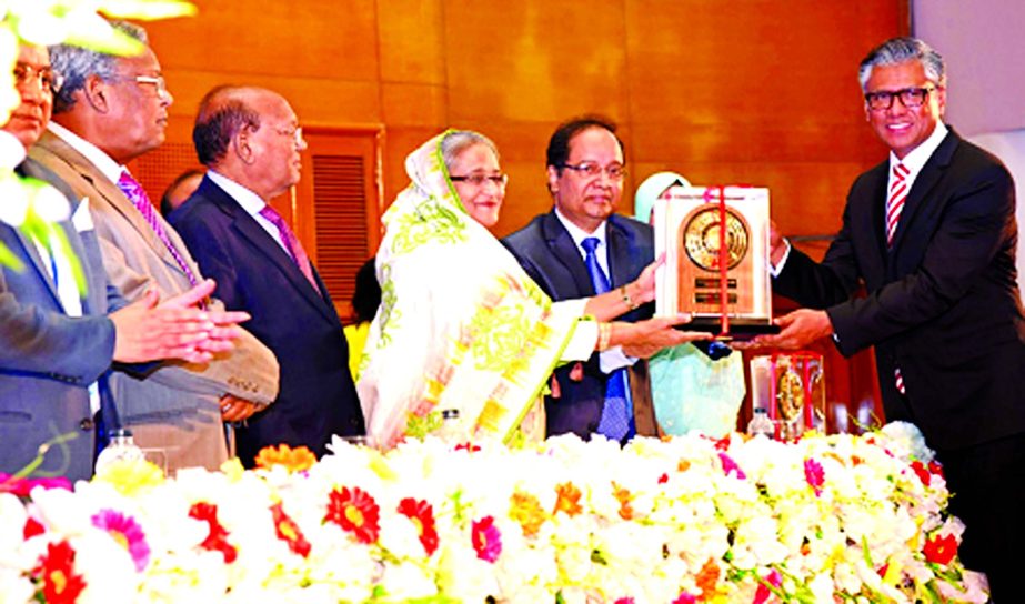 Shakhawat Hossain, Managing Director of Paramount Textile Ltd receiving National Export Trophy in Gold Category for the financial year 2013-2014 from Prime Minister Sheikh Hasina, at a program jointly organized by Export Promotion Bureau and Commerce Mini