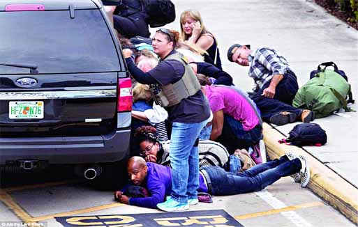 People take cover at the Ft. Lauderdale Airport after a gunman killed 5 people and injured many more. Internet photo