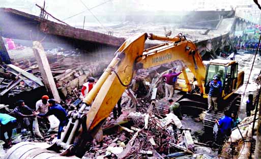 Bulldozer being used to remove debris of the partially collapsed DNCC market that caught the devastating fire early Tuesday gutting over 300 shops. This photo was taken on Saturday.