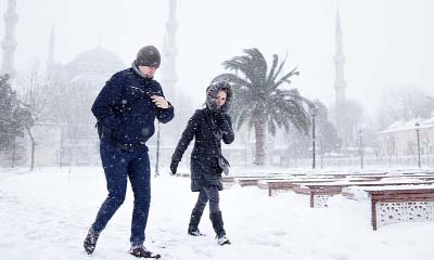 People walk in the snow, in the historic Sultanahmet district in Istanbul.