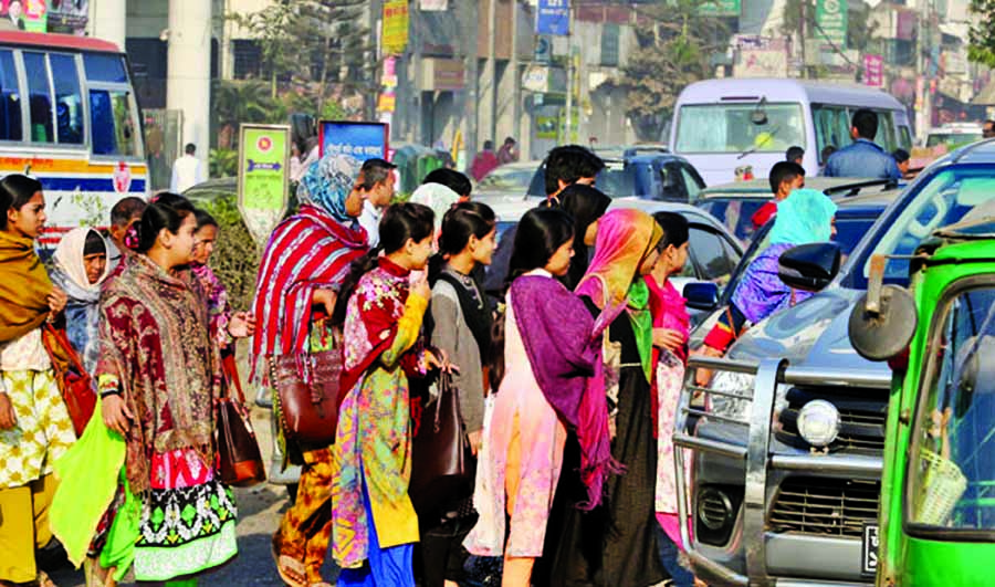 Pedestrians crossing the road on foot avoiding foot-over bridge.This unconsciousness may cause accident anytime. The snap was taken from the city's Shyamoli area on Tuesday.