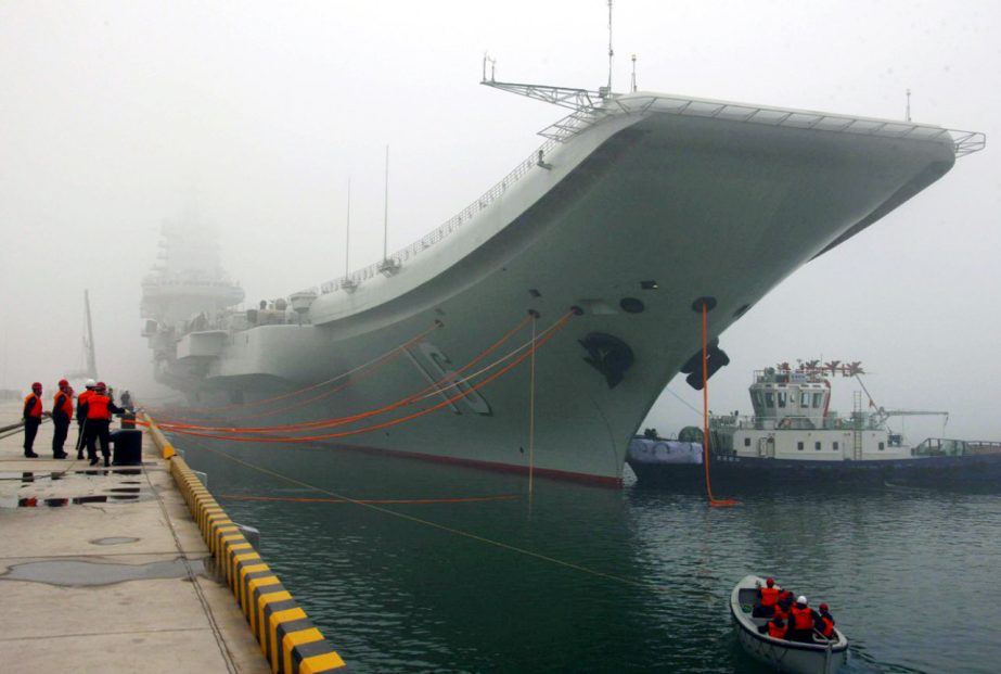 China's Xinhua news agency, China's first aircraft carrier, the Liaoning, is anchored in the northern port in Qingdao, east China's Shandong Province.