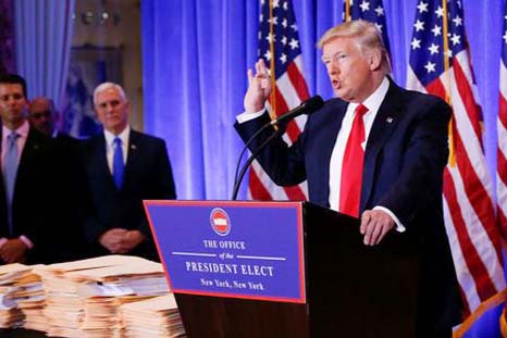 Vice President-elect Mike Pence is seen in the background as U.S. President-elect Donald Trump speaks during a press conference in Trump Tower, Manhattan, New York on Wednesday.