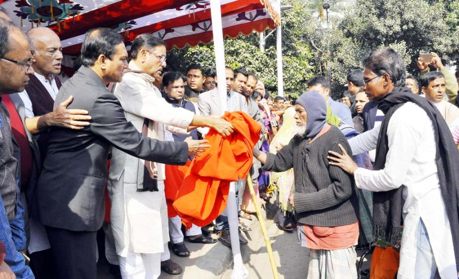 General Secretary of Awami League and Road Transport and Bridges Minister Obaidul Quader distributing winter clothes among the cold-hit destitute on behalf of Prime Minister in the city's Russel Square on Friday.