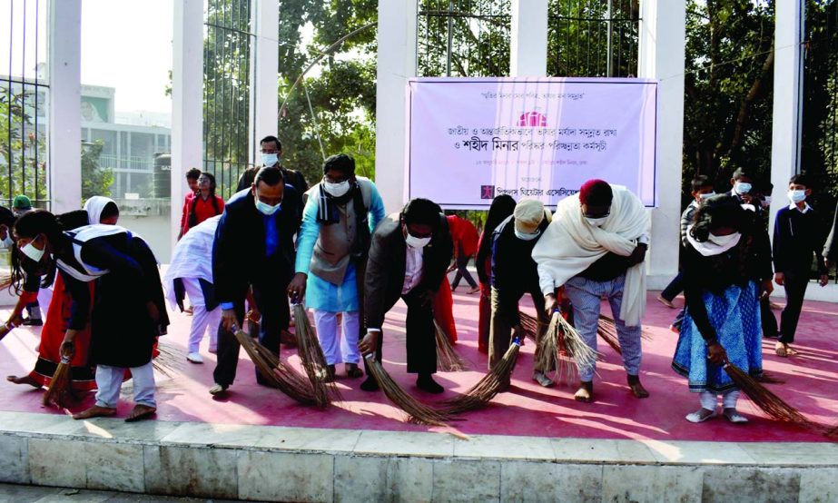 People's Theater Association cleansing the Central Shaheed Minar premises in the city on Friday as part of the cleansing programme of all shaheed minars all over the country to uphold the dignity of mother language.