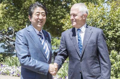 Japanese Prime Minister Shinzo Abe shaking hands with Australian Prime Minister Malcolm Turnbull at Kirribilli House in Sydney, Australia on Saturday.