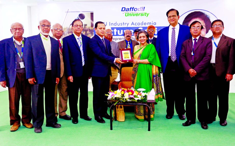 Sabur Khan, Chairman, Board of Directors of Daffodil International University handing over memento to Chairman of Adcomm Ltd and former Advisor to the Caretaker Government, Geeteara Safiya Chowdhury at DIU auditorium in the city on Saturday.