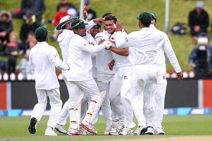 Taskin Ahmed is surrounded by team-mates after claiming Kane Williamson for his maiden Test wicket on the 3rd day of 1st Test at Wellington on Saturday.