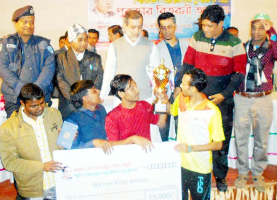 Chairman of the Parliamentary Standing Committee on Ministry of Railway communications ABM Fazle Karim Chowdhury MP giving the trophy to the winning team at the prize giving ceremony of the final match of Fazlul Kabir Chowdhury Memorial Badminton Gold