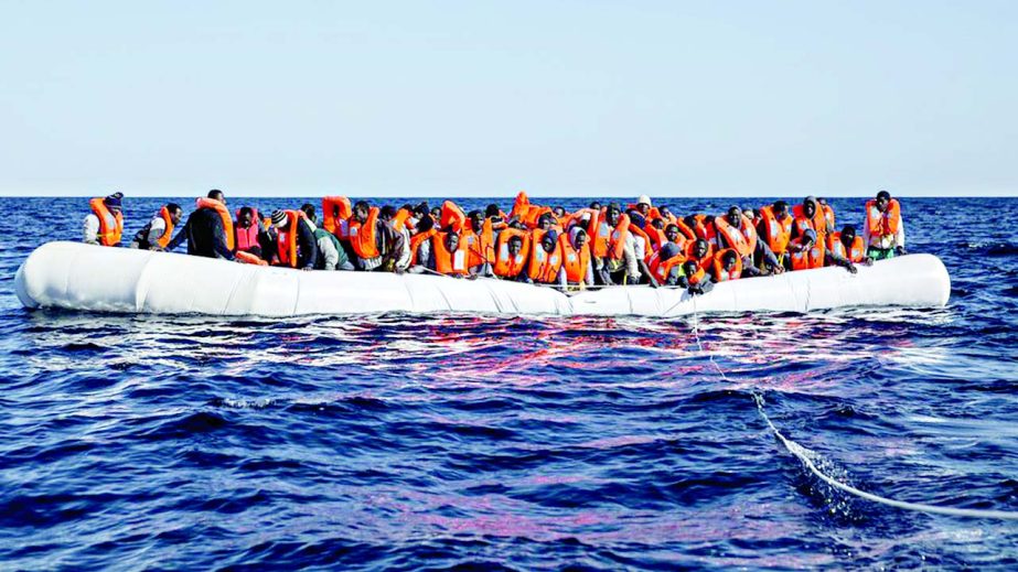 Photo shows migrants crowded on to an inflatable dinghy before rescue off Libya's coast.