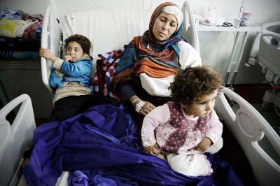 Um Yousef and her two young daughters recover in an Irbil hospital after they were badly injured in a mortar attack outside their home in Mosul, Iraq on Sunday