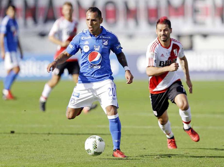 Millonarios FC's Juan Cabeza (20) moves the ball away from River Plate's Rodrigo Mora (right) during the second half of a Florida Cup soccer match on Sunday.