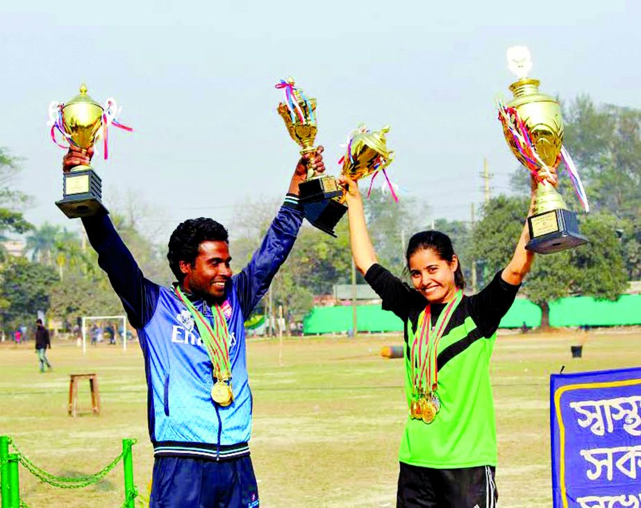 G M Hasan (left) and Mariam Akhter pose with their trophies on Monday.