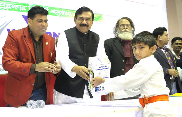 Minister for Shipping Shajahan Khan handing over a prize to a winner of the Walton National Martial Art Competition as the chief guest at the gymnasium of National Sports Council on Tuesday. Agency photo