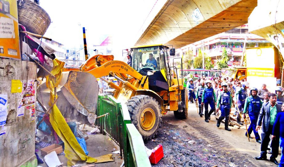 Dhaka South City Corporation authority demolishing the illegal establishments under the Hanif Flyover in Gulistan area on Tuesday.