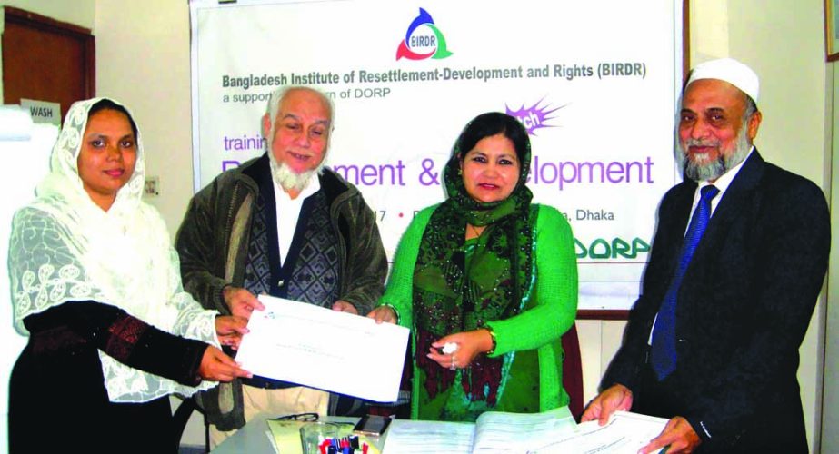 Shahnawaz Dilruba Khan, Additional Director, Department of Woman Affairs, distributing certificates among the participants after a 4-days training workshop arranged by Bangladesh Institute of Resettlement Development and Rights (BIRDR) in the city recentl