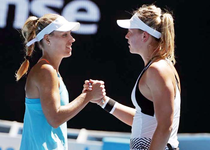 Germany's Angelique Kerber (left) is congratulated by compatriot Carina Witthoeft after wining their second round match at the Australian Open tennis championships in Melbourne, Australia on Wednesday.