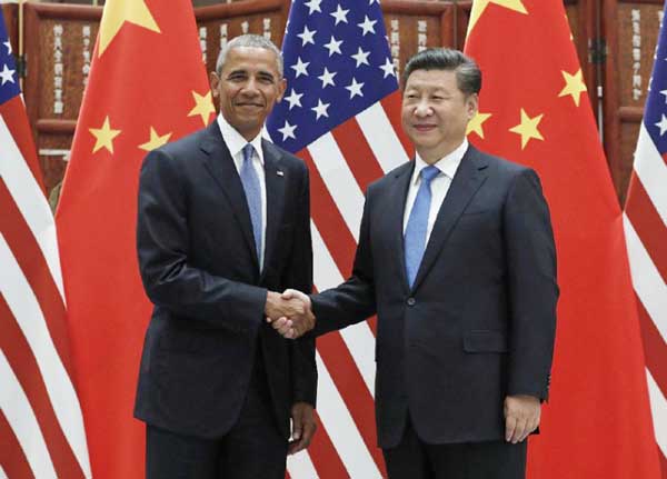 US President Barack Obama, (left) and Chinese President Xi Jinping pose for photographers as they shake hands before a bilateral meeting at Westlake State House in Hangzhou in eastern China's Zhejiang province.
