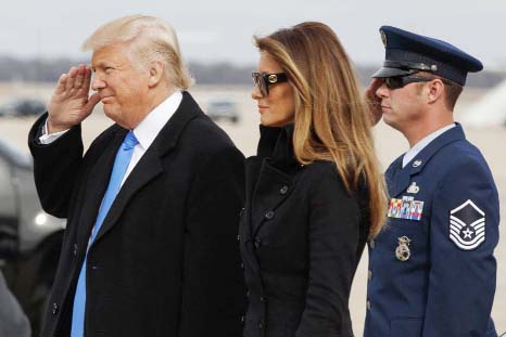 President-elect Donald Trump salutes as he and his wife Melania arrive at Andrews Air Force Base, Md. on Thursday ahead of Friday's inauguration.
