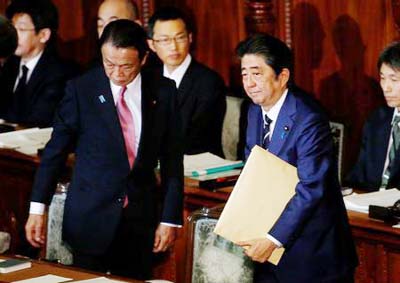 Japan's Prime Minister Shinzo Abe Â® and Deputy Prime Minister and Finance Minister Taro Aso attend the ordinary session of parliament in Tokyo on Friday.