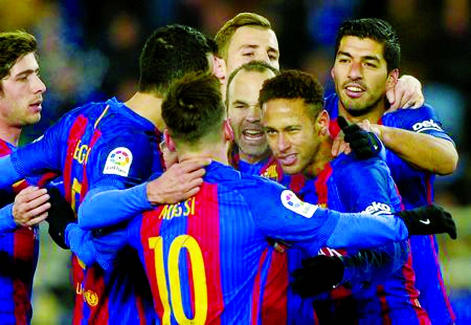 Barcelona's Neymar celebrates with team-mates Lionel Messi and Luis Suarez after scoring Barcelona's first goal against Real Sociedad in a first-leg quarterfinal of the Copa del Rey at Anoeta Stadium in Spain on Thursday.