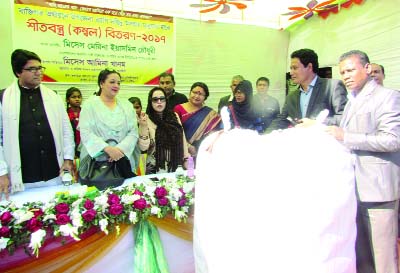 KULAURA(Moulvibazar): Women entrepreneur Mrs Merina Yasmin Chowdhury, Sponsor Director, Prime Bank Ltd donated winter clothes to union chairmen of 13 Union Parishads at Kulaura Railway Junior High School premises yesterday.