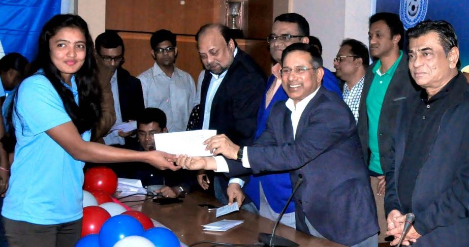 Managing Director of Envoy Group and Senior Vice-President of Bangladesh Football Federation (BFF) Abdus Salam Murshedy handing over a cash of Taka twenty thousand to a member of Bangladesh National Women's Football team at the conference room of BFF Hou