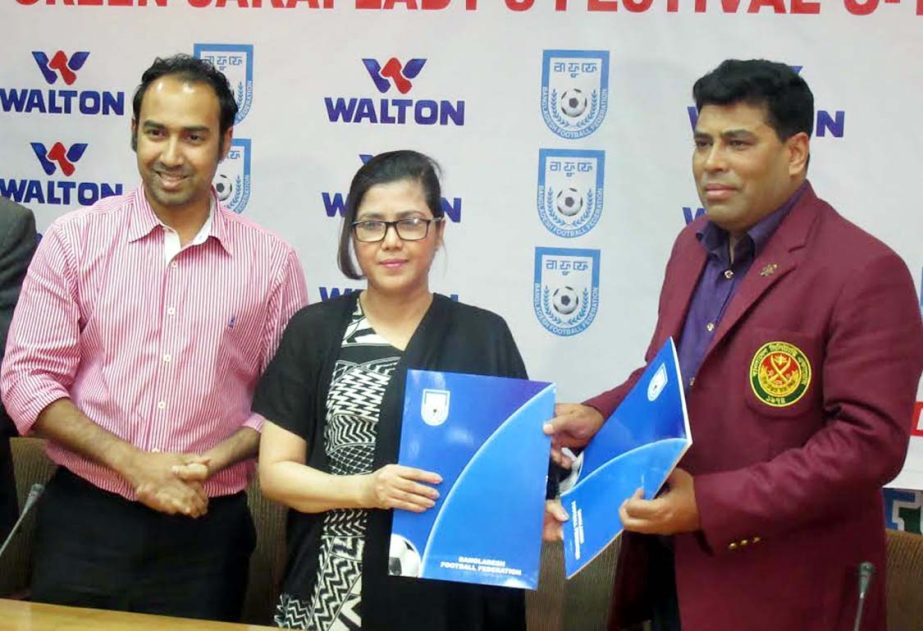 Head of Sports and Welfare Department of Walton Group FM Iqbal Bin Anwar Dawn (right) exchanging papers with Mahfuza Akter Kiron, Chairperson of the Women's Wing of Bangladesh Football Federation (BFF) after signing an MoU at the conference room of BFF H
