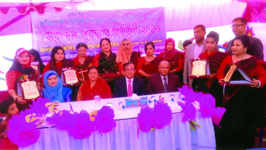 Anwarul Karim, Director General, Department of Youth Development, handing over prize among ten new entrepreneurs and trainees of the Training Center of Protibeshi Cottage Industry at a ceremony held at Mirpur in the city recently.