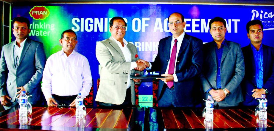 Anisur Rahman, Chief Operating Officer of PRAN Beverage Limited and Lt Gen (Rtd) Masud Uddin Chowdhury, Chairman of Picasso Restaurant exchange documents after signed an agreement at the Restaurant in the city recently. As per the deal, Picasso Restauran