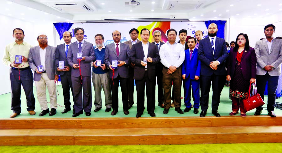 Chairman of Daffodil Family Md Sabur Khan along with others at the inaugural ceremony of own mobile brand DCL mobile in Bangladesh market at a ceremony held in the auditorium of Daffodil Family in the city on Thursday.