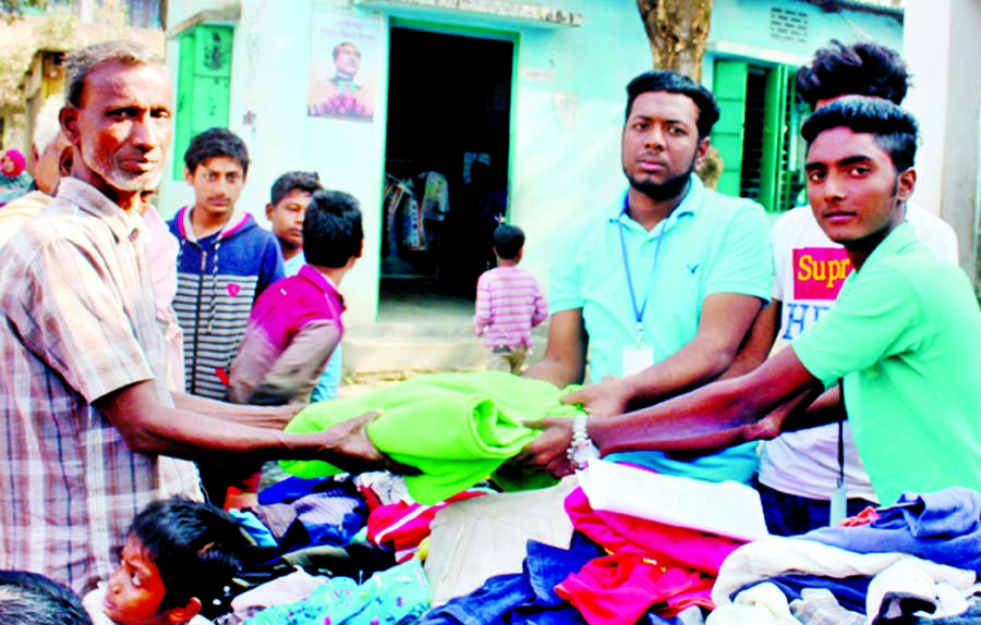 Youth for Humanity, a voluntary organisation distributing winter clothes among the destitute at a function held recently at Belna Khaskandi Government Primary School premises under Keraniganj Upazila.