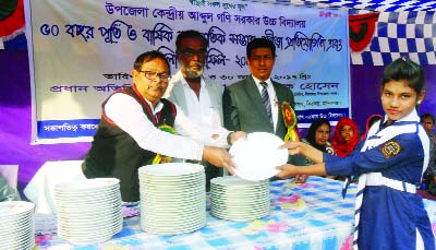 MANIKGANJ: SMC Chairman Md. Mobarak Hossain distributing prizes among the winners of annual sports competition of Uthali AGS High School on Thursday.