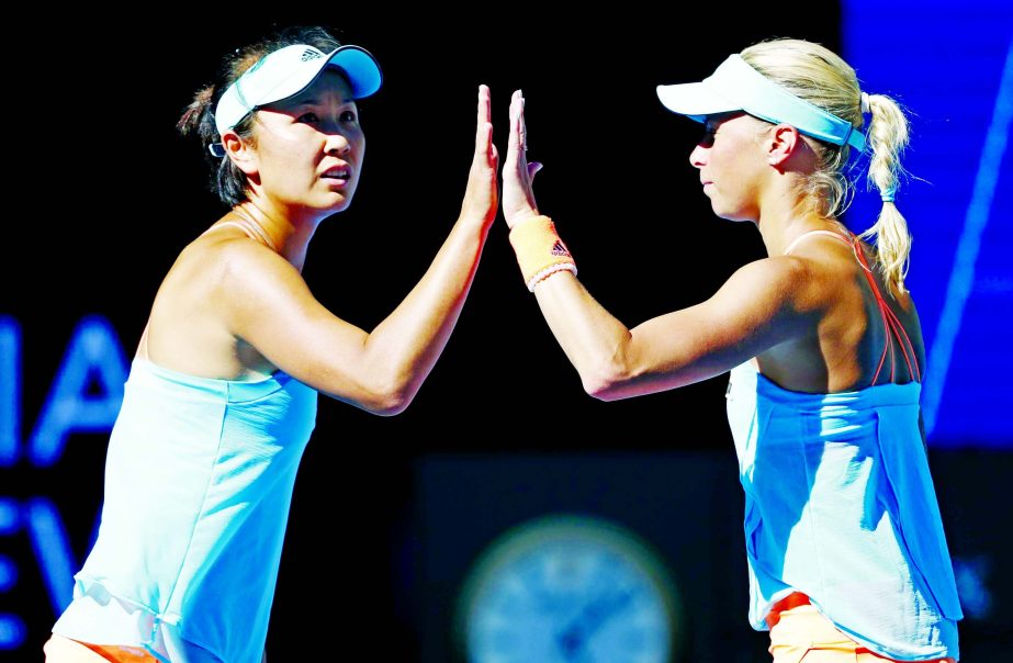 Andrea Hlavackova (right) of the Czech Republic and partner Peng Shuai of China celebrates a point win during the women's doubles final against Bethanie Mattek-Sands of the U.S. and Lucie Safarova of the Czech Republic at the Australian Open tennis champ
