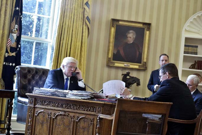 US President Donald Trump speaks on the phone with Russia's President Vladimir Putin from the Oval Office of the White House on Saturday in Washington, DC. AP Photo