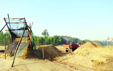 SREEBARDI(Sherpur): Illegal sand lifting from Someshawari River going on at Ranishimul Union of Sreebardi Upazila border side point. This snap was taken yesterday.