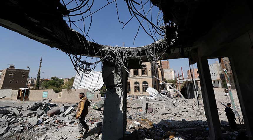 A man stands at the site of Saudi-led air strikes that destroyed several houses in Yemen's capital Sanaa.