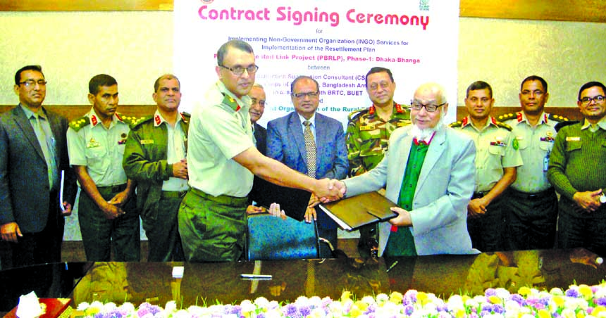 Colonel Noor-e-Alom Md Jobayer Sarwar, In-Charge (land acquisition) of CSC-Bangladesh Army and AHM Nouma, CEO of DORP, a non-government organisation exchanging documents after signing a deal for implementation of resettlement plan for the padma bridge rai
