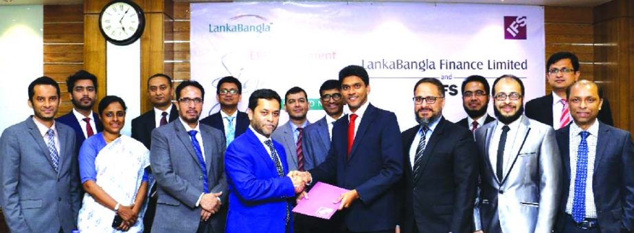 Asanga Marasinghe, Country Director IFS Bangladesh handing over the agreement paper to Mohammed Nasir Uddin Chowdhury, Managing Director LankaBangla Finance Limited (LBFL). Shiraz Lye, Director Sales and Marketing, IFS South-Asia, Zahid Khan, Head of Ope