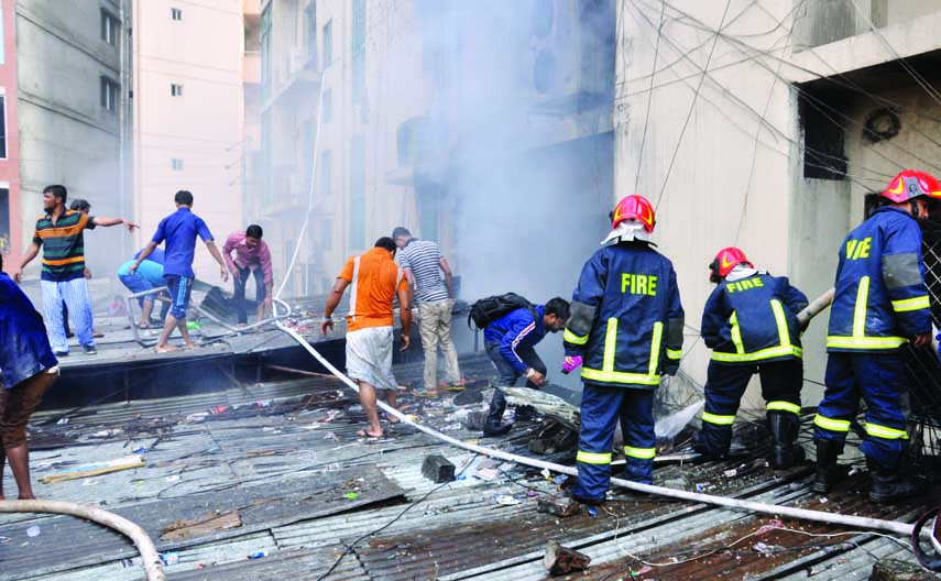 Fire fighters trying to extinguish fire broke out at a building at Purana Paltan in the city yesterday.