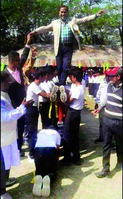 Noor Hossain Patwari, Upazila Chairman and General Secretary of Awami League of Haimchar Upazila of Chandpur district riding on a human bridge during a sport event of a school on its campus recently. Collected photo