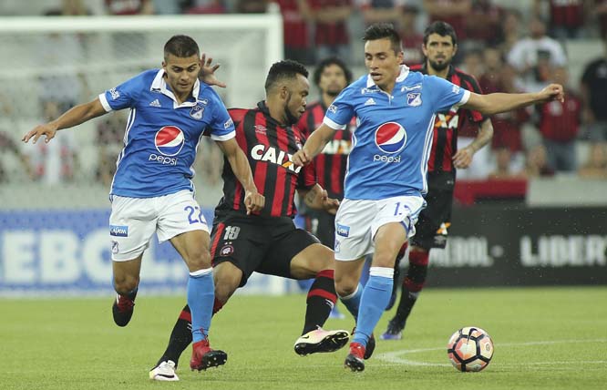 Carlos Alberto Brazil's Atletico Paranaense eyes the ball flanked by Jhon Duque (left) and Henry Rojas of Colombia's Millonarios during a Copa Libertadores soccer match in Curitiba, Brazil on Wednesday.