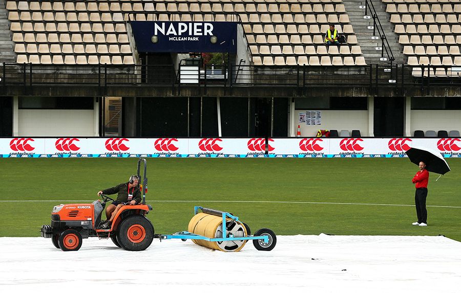 Ground staff tend to the covers following a spell of rain before the match of 2nd ODI between New Zealand and Australia at Napier on Thursday.