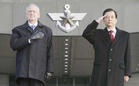 US Defense Secretary Jim Mattis, left, and South Korean Defense Minister Han Min Koo salute during a welcome ceremony for Mattis at Defense Ministry in Seoul, South Korea on Friday.