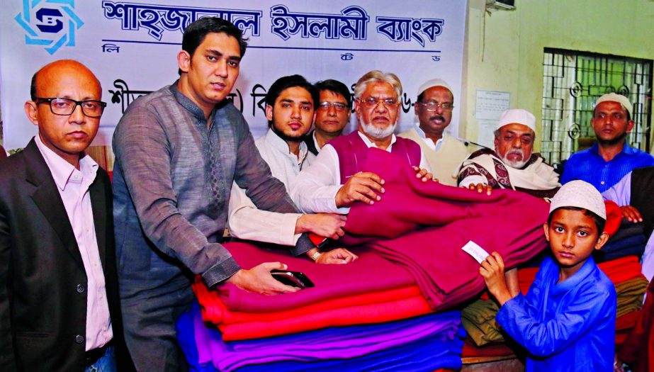 Vice-Chairman of Board of Directors of Shahjalal Islami Bank Ltd. Mohiuddin Ahmed recently distributed Blankets among winter hit poor people in Dilu Road Mosque premises in the city as part of CSR activities of the Bank. Among others, Director of the bank